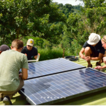 Volunteers putting a solar panel up