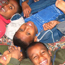 Volunteer with children in Ethiopia - Bamboo