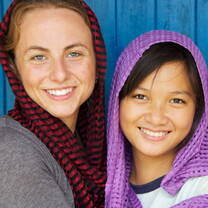 Volunteers wearing scarves woven at the Microenterprise & Fashion Design Program