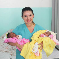 Nurse with two new borns in hospital