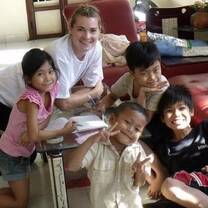 Volunteers helping with homework in Cambodia