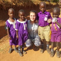 Volunteer with children in Uganda