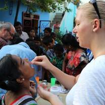 Volunteer gives a child vitamins